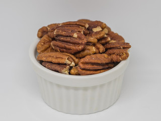  pecan nuts  in the white cup