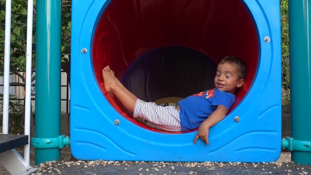 4K Cute child found a cozy place to rest at the children plaground