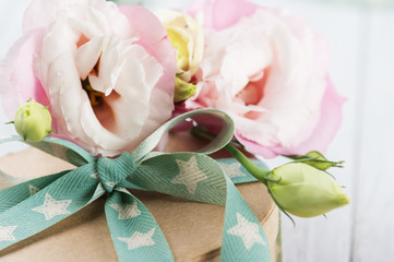 Eustoma flower and gift box with star green ribbon