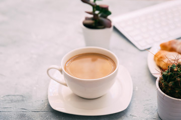 Obraz na płótnie Canvas Morning Coffee mug with croissant and keyboard