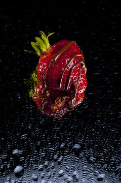 red strawberry with cholocate dripping on it 