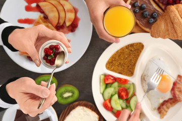 Family having tasty breakfast at table