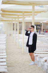 Fototapeta premium Young fashionable man on the beach, cool