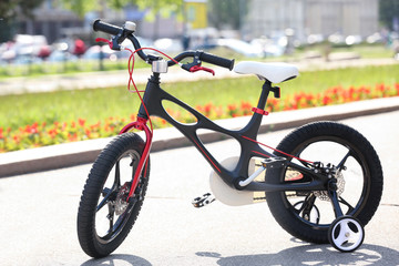 Fototapeta na wymiar Modern children's bicycle outdoors on sunny day