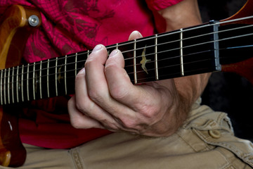 Fototapeta na wymiar closeu up man playing chords on electric guitar 