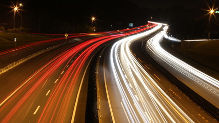Speed Traffic - light trails on motorway highway at night, long exposure abstract urban background
