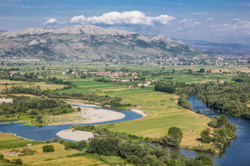 Beautiful landscape with river during sunny summer day. Shkoder city in Albania seen from the top of the mountain. 