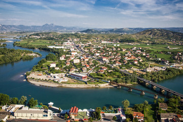 Fototapeta na wymiar Albania Shkoder city seen from the top of the mountain. Beautiful landscape with river during sunny summer day.