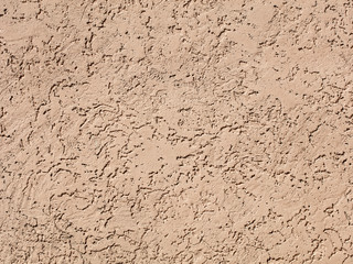 Beige plaster on wall, plasterwork, sand texture