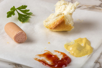 Eating Sausages (Frankfurter) with bread, mustard and ketchup