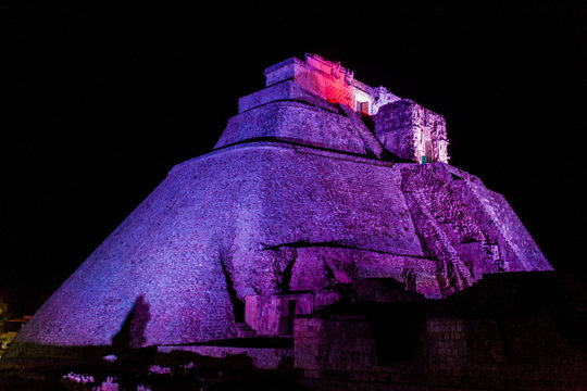 Nightly illuminated Pyramid of the Magician (Piramide del adivino) in ancient Mayan city Uxmal, Mexico