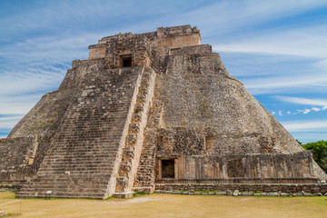 Fototapeta na wymiar Pyramid of the Magician (Piramide del adivino) at the ruins of the ancient Mayan city Uxmal, Mexico