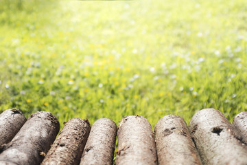 Rustic wood log table perspective and blurred green background