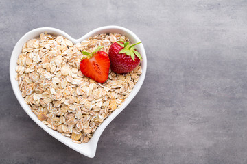 Dry rolled oatmeal in bowl.