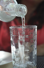 Pour drinking water into the glass