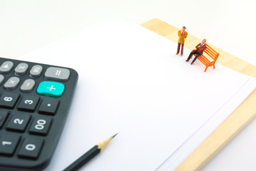 Miniature business man on white document paper