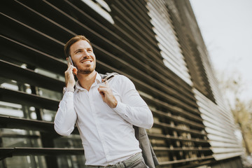 Young successful men entrepreneur using mobile phone outdoor