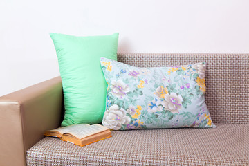 Bamboo pillows. 
Bamboo pillows and a book on a modern sofa.