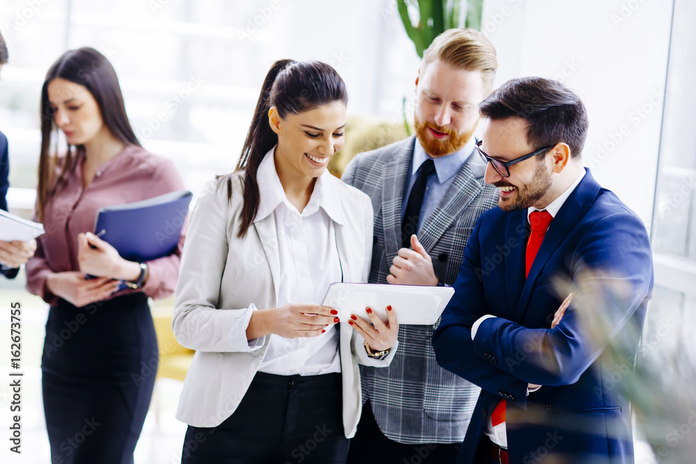 Wall mural businesspeople standing in the modern office