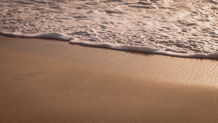 Gentle Wave Rolling over Sandbeach in Sunset light, Beautiful Crystal Bay, Nusa Penida Bali