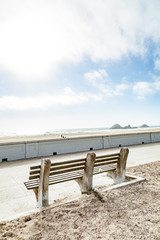 Fototapeta na wymiar stone bench overlooking beach