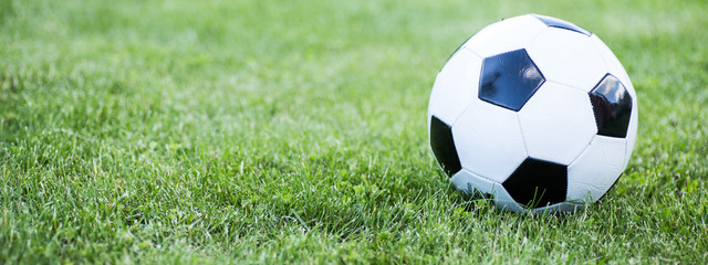 Fototapeta na wymiar Traditional soccer ball on soccer field.