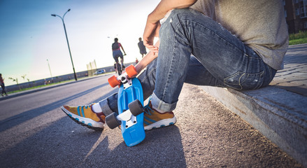 man with a skateboard sits