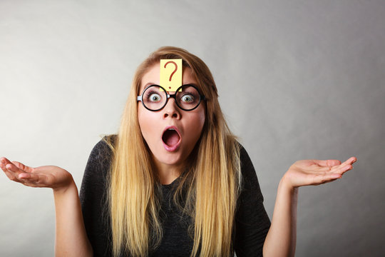 Weirdo nerd woman having question mark on forehead
