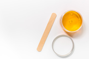 Wax and stick for depilation on white background top view copyspace