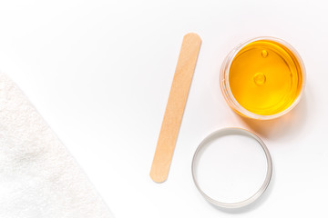 Wax and stick for depilation on white background top view copyspace