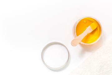 Wax and stick for depilation on white background top view copyspace
