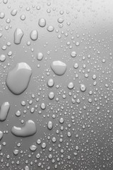 Fototapeta na wymiar Raindrops on a grey surface, background