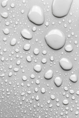 Close-up of raindrops on grey surface