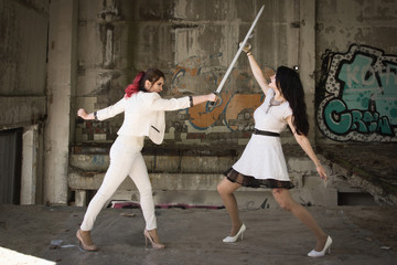 Two businesswomen are fighting at swords.