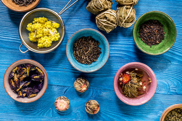 herbal and green tea for tea-house blue wooden desk background flat lay pattern
