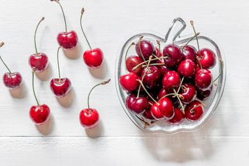 Naklejka na ściany i meble A lot of cherry in bowl on white background top view