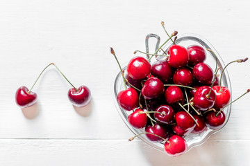 Naklejka na ściany i meble A lot of cherry in bowl on white background top view