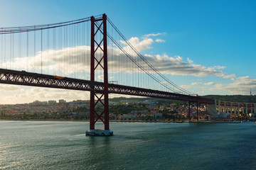 View of Lisbon, Portugal and the Abril 25 (April 25) suspension bridge in late afternoon light on a clear day