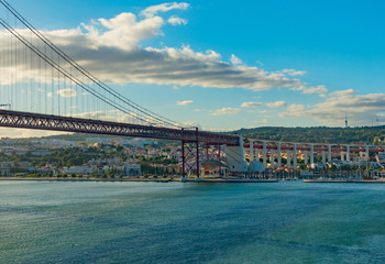 View of Lisbon, Portugal and the Abril 25 (April 25) suspension bridge in late afternoon light on a clear day