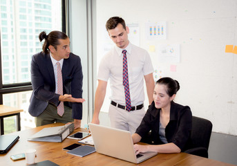 Business team having using laptop during a meeting and presents.