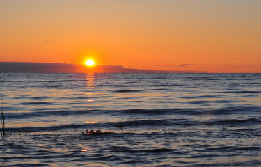 Dawn at the Ladoga. The sun rising above the lake reflecting in the waves