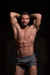 Fototapeta na wymiar Handsome Model Flexing Muscles