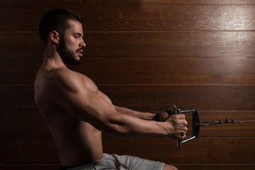 Fototapeta na wymiar Muscular Model Doing Heavy Weight Exercise For Back