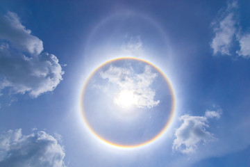 sun corona rainbow clouds and blue sky background , Circumscribed halo