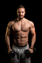 Fototapeta na wymiar Man Exercise Biceps With Dumbbells On Black Background