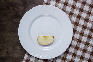 White plate with a slice of apple