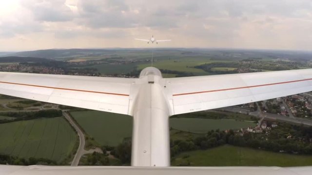 Aerotowing glider start and flight over urban landscape around Pilsen in Czech Republic, Central Europe. Footage from action camera placed on aircraft elevator. Soaring under clouds. 