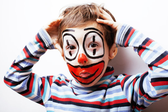 little cute boy with facepaint like clown, pantomimic expression