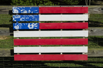 Painted fense section colored like the American Flag