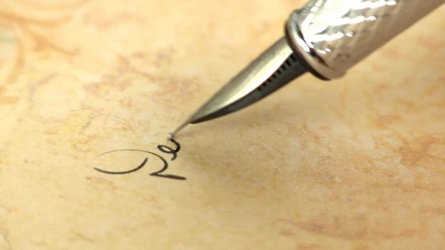 Macro shot of fountain pen writing on paper